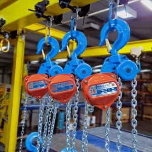 WH C4 QT chain hoists with blue hooks and silver chains hanging from a yellow overhead beam